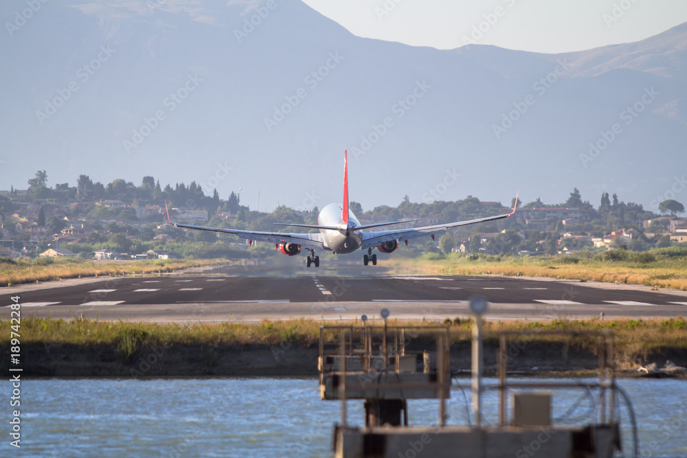 Fototapeta premium Airplane landing on Corfu airport