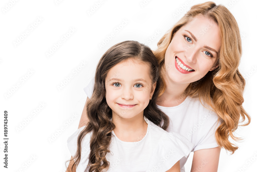portrait of smiling mother and daughter looking at camera isolated on white portrait of smiling mother and daughter looking at camera isolated on white