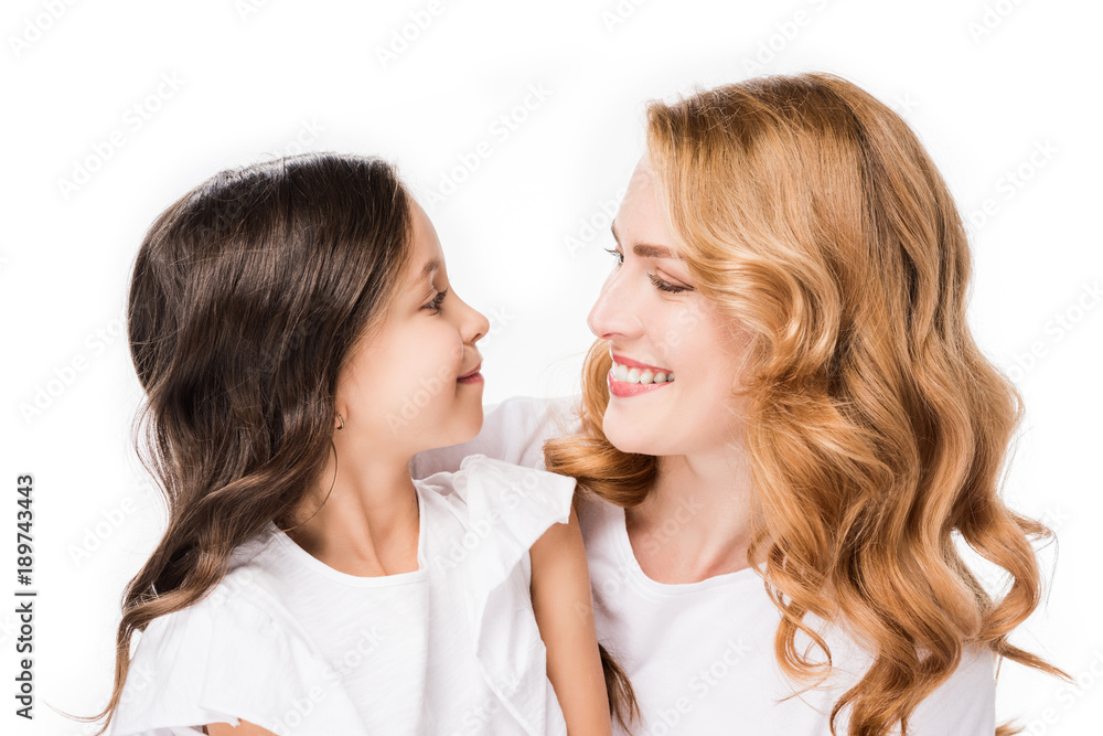 portrait of smiling daughter and mother looking at each other isolated on white portrait of smiling daughter and mother looking at each other isolated on white