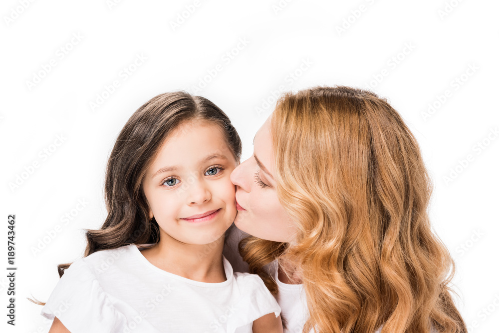 portrait of mother kissing little daughter isolated on white portrait of mother kissing little daughter isolated on white