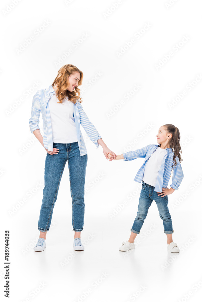 mother and little daughter holding hands isolated on white mother and little daughter holding hands isolated on white