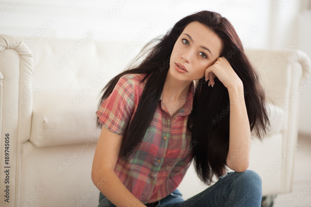 hipster Woman sitting near white leather sofa hipster Woman sitting near white leather sofa