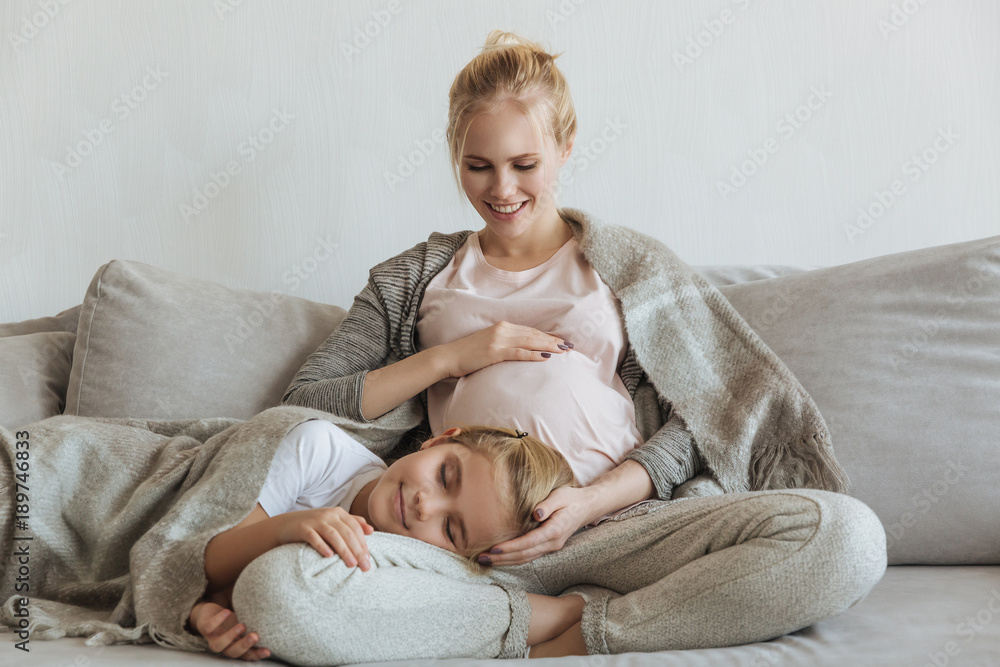 daughter sleeping on pregnant mother legs daughter sleeping on pregnant mother legs