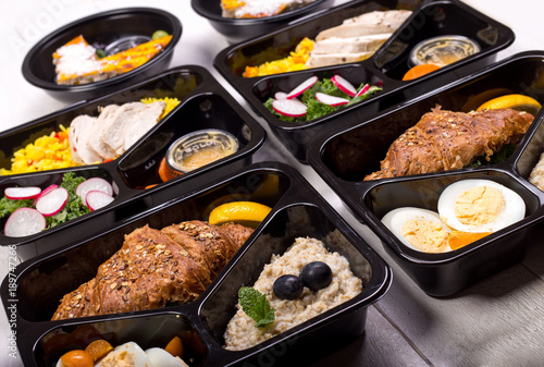 Different types of takeaway food in microwavable containers. Fresh and healthy meal for fitness and bodybuilding.