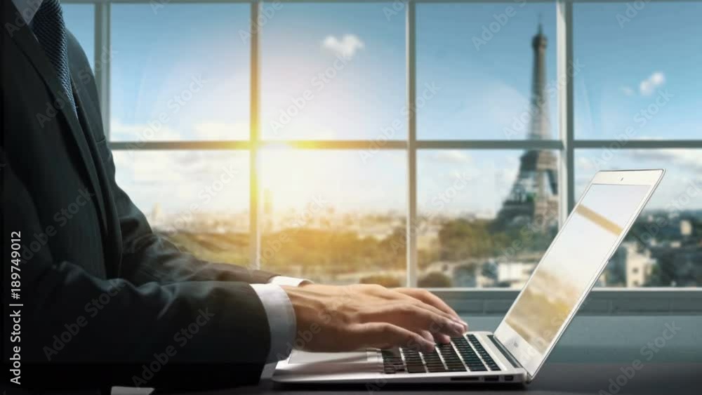 View of Paris France.Close up hand Businessman using laptop View of Paris France.Close up hand Businessman using laptop