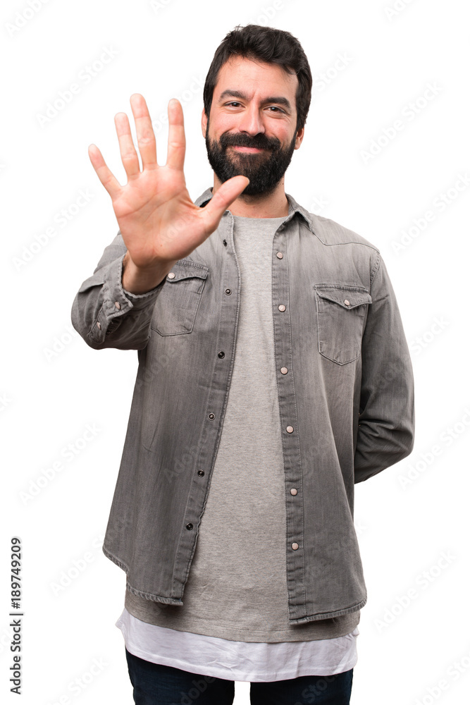 Handsome man with beard counting five on white background Handsome man with beard counting five on white background