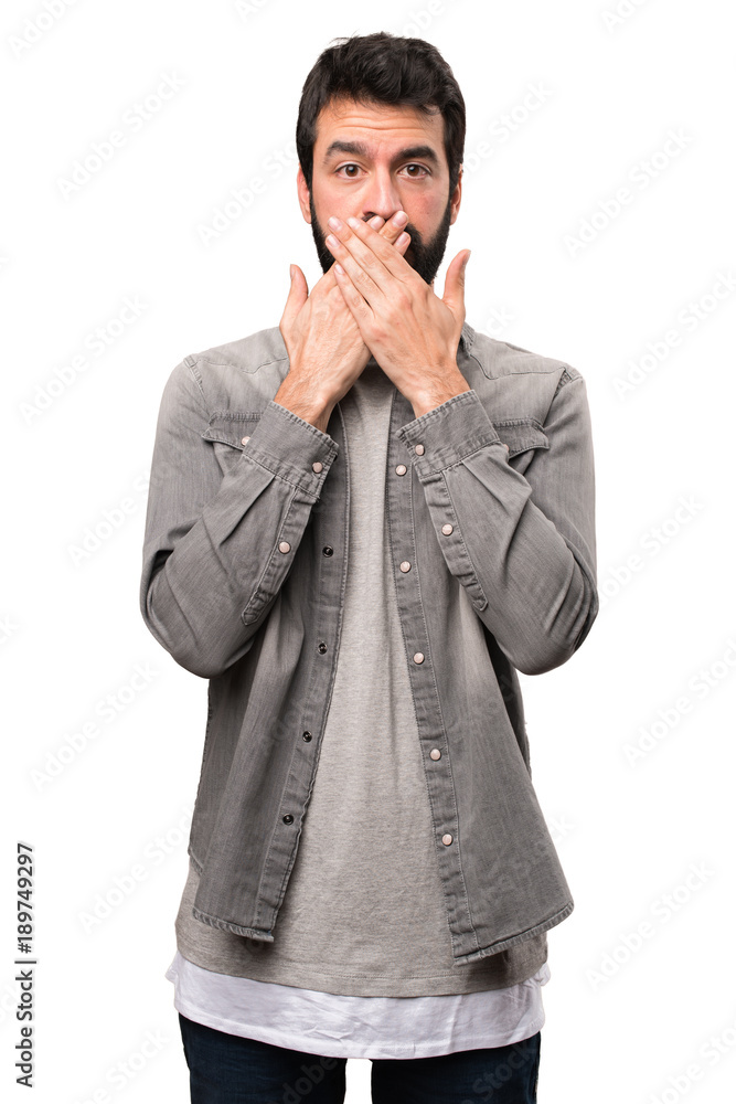 Handsome man with beard covering his mouth on white background Handsome man with beard covering his mouth on white background