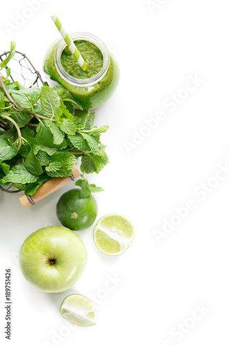 Green healty drink in mason jar with green apple, mint and lime on white background. Vegetarian food concept. Detox. Text space