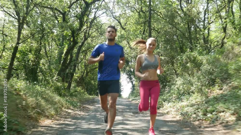 beautiful young couple running sport fitness exercising together outdoor countryside forest beautiful young couple running sport fitness exercising together outdoor countryside forest