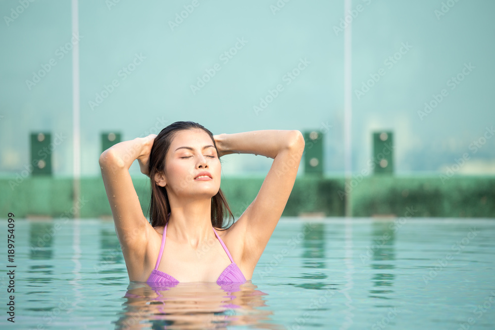 Asian woman resting at pool. Woman with relax emotion.