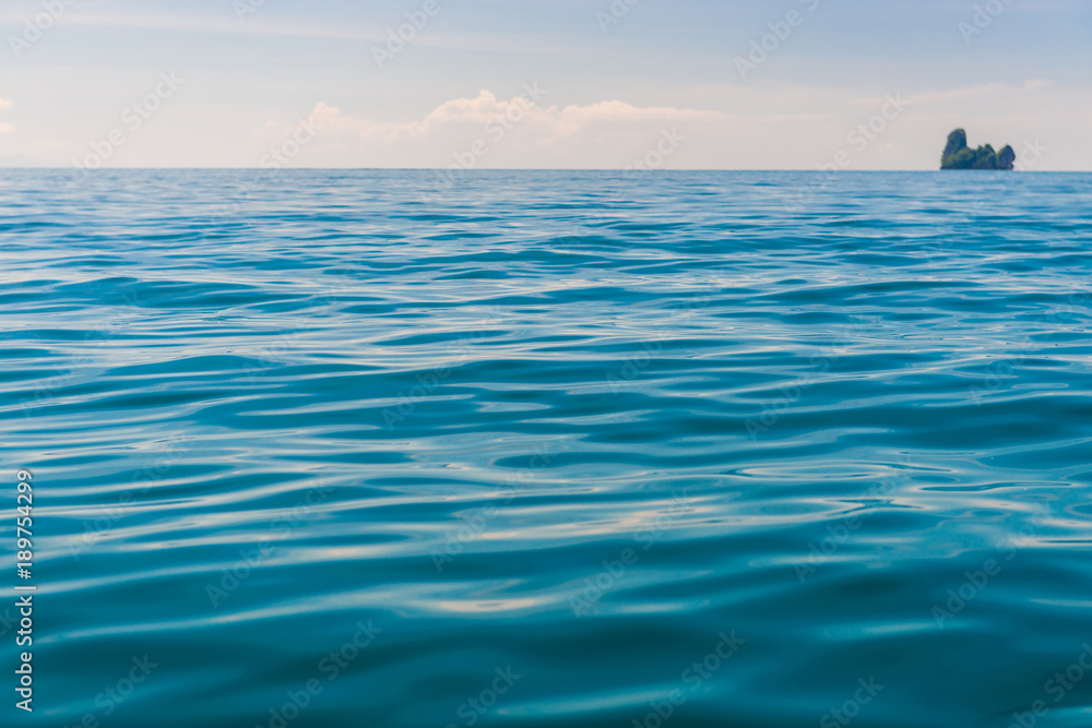 Fototapeta premium Andaman Sea, close-up water and an island on the horizon