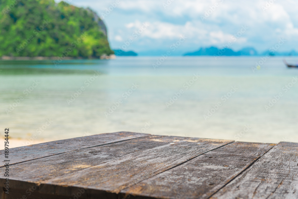 Textured wooden table surface against the background of the sea in the tropics