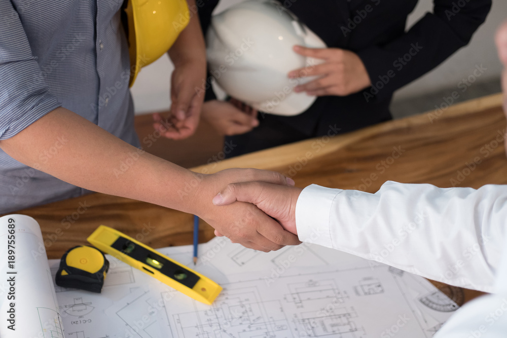 Architect & customer shaking hands. Engineer handshaking with partner ...