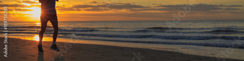 Runner legs on the beach during the sunrise. © cegli