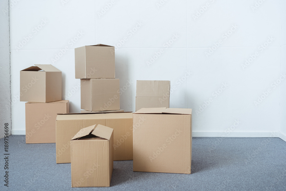 stacks of cardboard boxes in empty room during relocation stacks of cardboard boxes in empty room during relocation