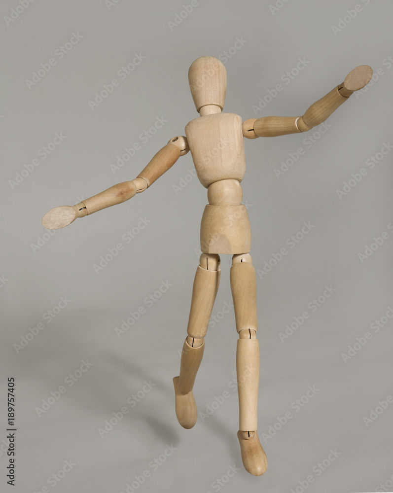 puppet in motion on grey background puppet in motion on grey background