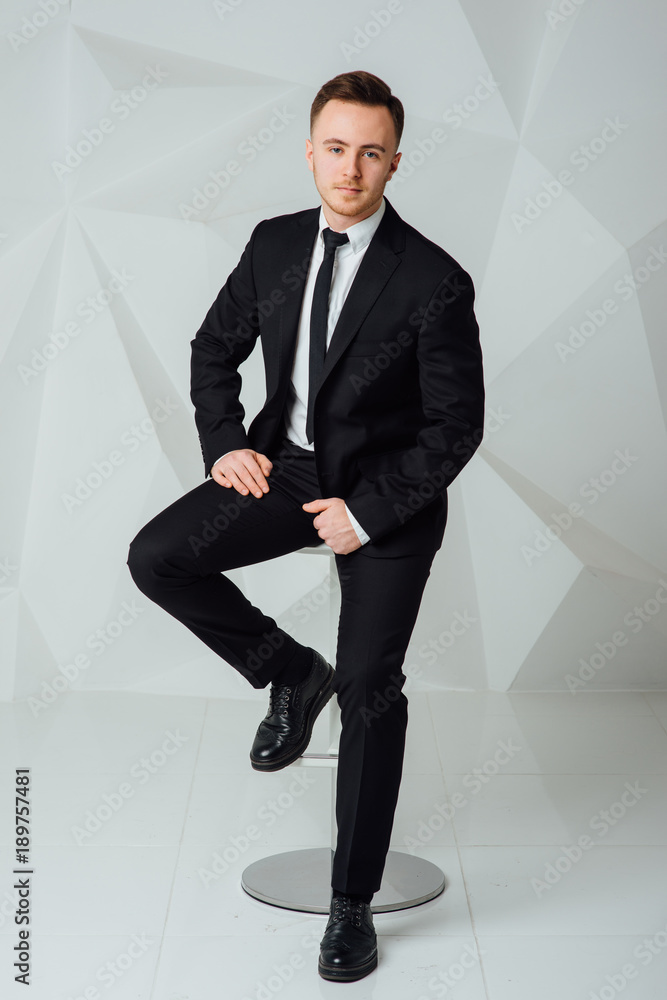 young business man in modern suit sitting on chair