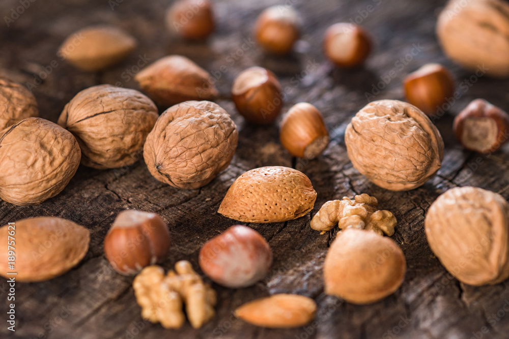 Mixed Nuts on Rustic Wooden Table Mixed Nuts on Rustic Wooden Table