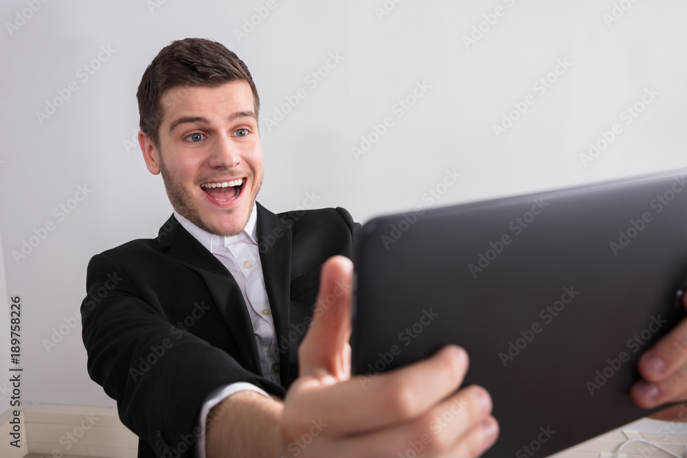 Happy Businessman Looking At Digital Tablet Happy Businessman Looking At Digital Tablet