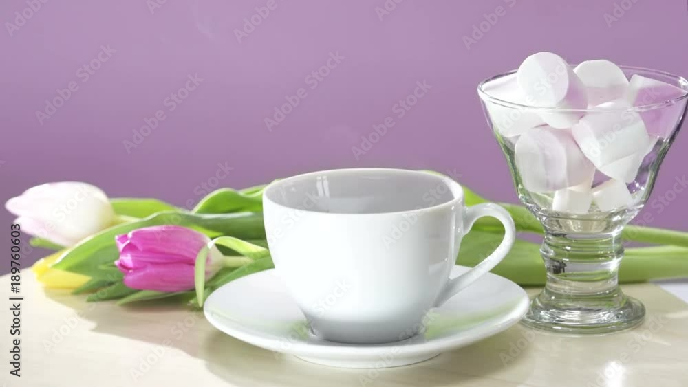 Romantic breakfast, Pouring fresh hot Coffee Into Cup in morning. Steaming drink with flowers and Doughnuts Romantic breakfast, Pouring fresh hot Coffee Into Cup in morning. Steaming drink with flowers and Doughnuts