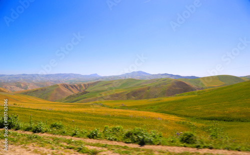 Rural landscape. Green hills, blue sky