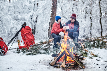 Tourists on a halt in the winter forest