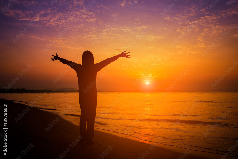 Silhouette woman on the beach at sunset. Vintage tone