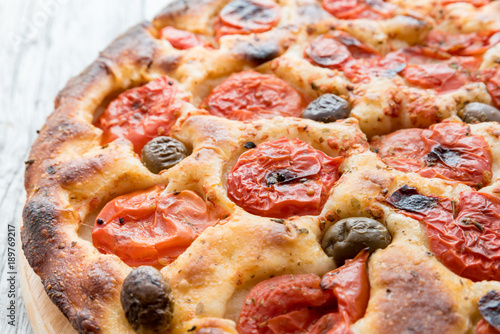 Focaccia typical of Bari Italy with tomatoes and olive photo