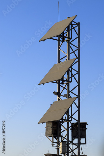 Solar panels on blue sky background , traffic light's power supply unit 
