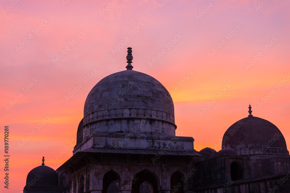Mandu India, afghan ruins of islam kingdom, mosque monument and muslim tomb. Colorful sky at sunrise.