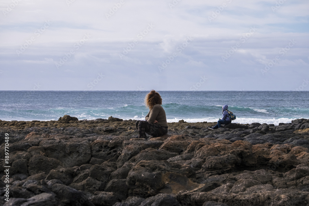 Two people man and woman stay looking at the ocean power