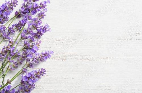 Fototapeta Naklejka Na Ścianę i Meble -  Sprigs of lavender on  wooden shabby background.