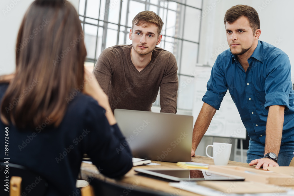 Three work colleagues in a serious discussion Three work colleagues in a serious discussion