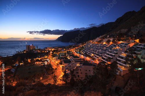 residential apartments in the background of Los Gigantes Cliffs, Tenerife, Spain