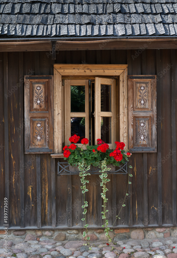Traditional classic European wooden facade with window shutters