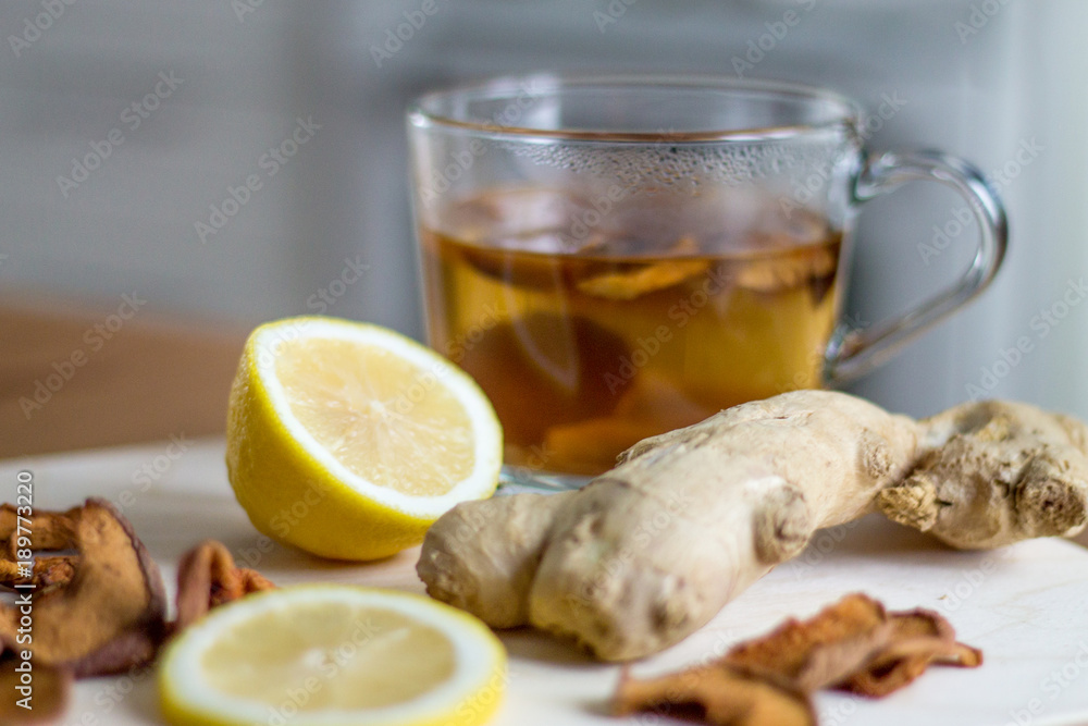 Home made hot dried apple drink with lemons and ginger, kitchen interior Home made hot dried apple drink with lemons and ginger, kitchen interior