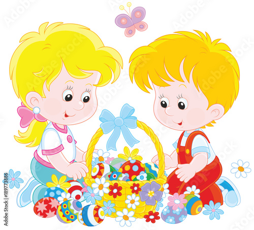 Little children with a decorated Easter basket of colorfully painted eggs and flowers