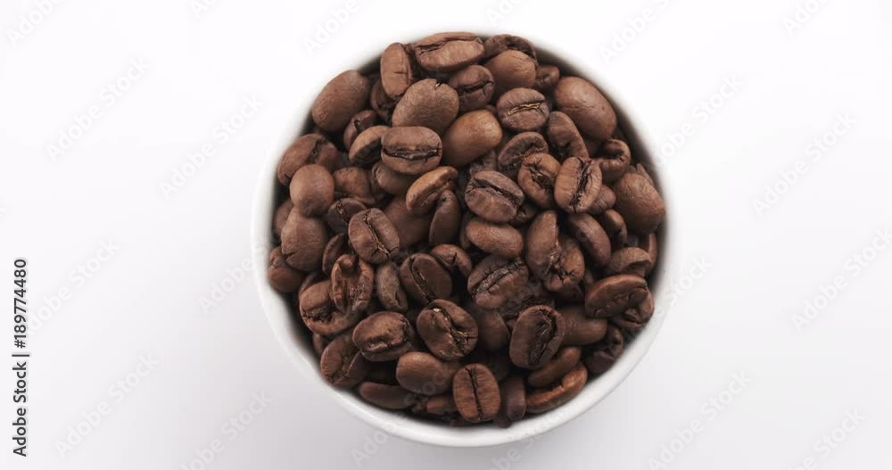 roasted coffee beans in white bowl on white background rotating loop roasted coffee beans in white bowl on white background rotating loop