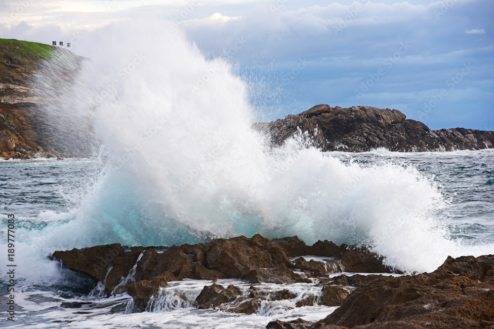 Wave crashing against a rock in Alghero shore