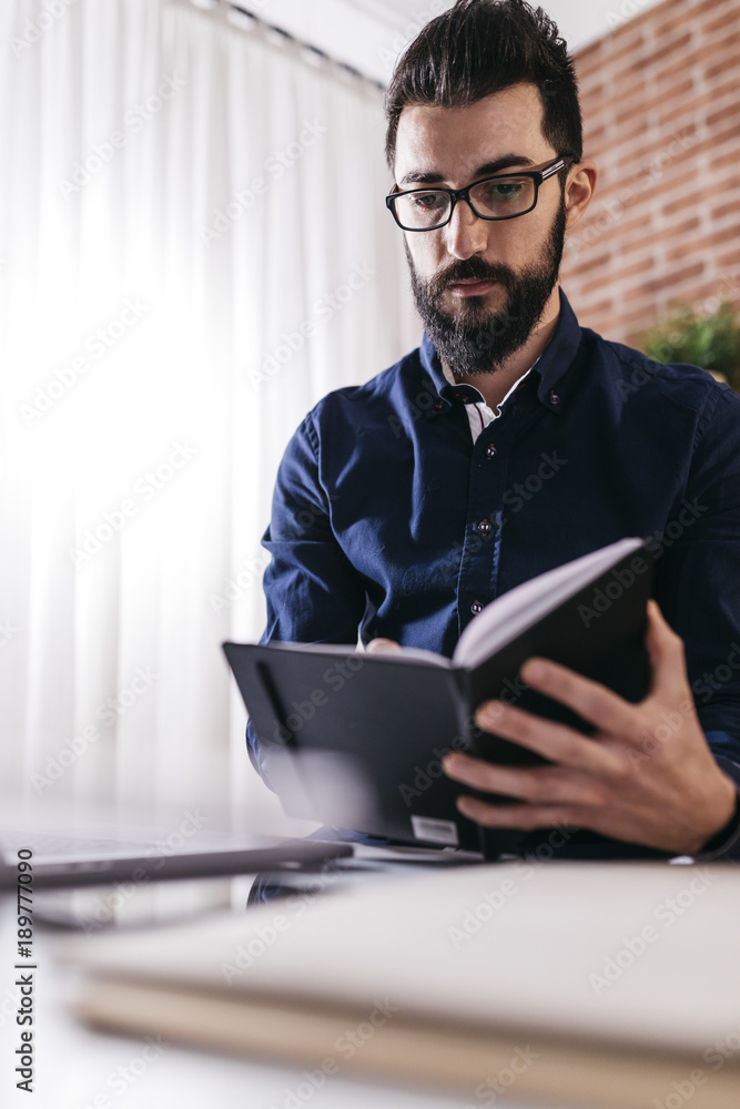 Elegant man taking notes planner Elegant man taking notes planner