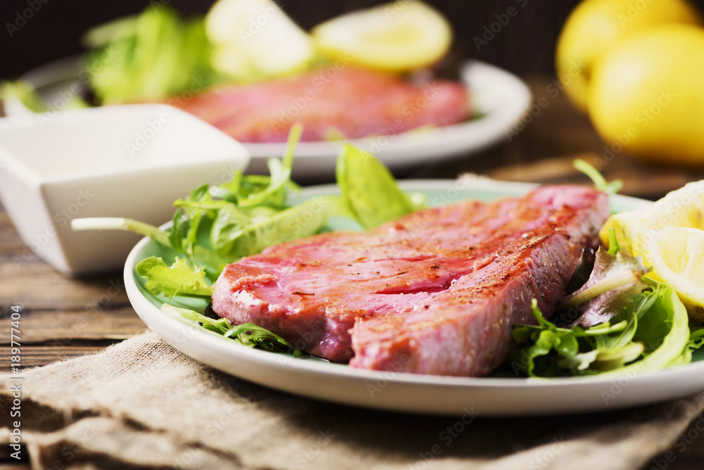 Cooked delicious tuna fish with green salad Cooked delicious tuna fish with green salad