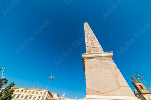 Flaminio obelisk in Piazza del Popolo under a blue sky photo