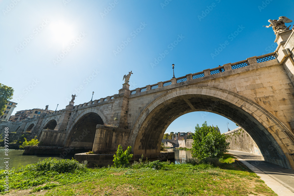 Sun shining over Sant Angelo bridge in Rome