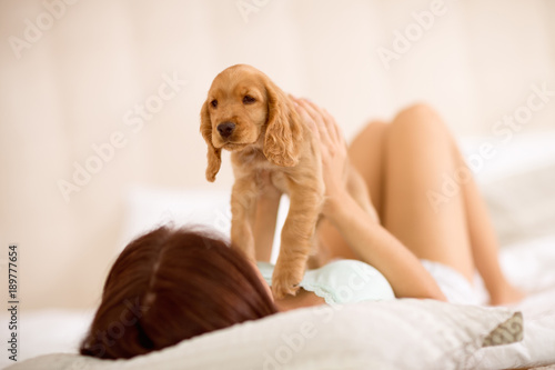 Girl adore his puppy race Cocker Spaniel.