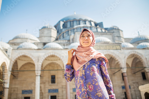 Photography Happy attractive muslim woman in Istanbul, Turkey, posing in courtyard of Suleymaniye mosque, religion and travel concept