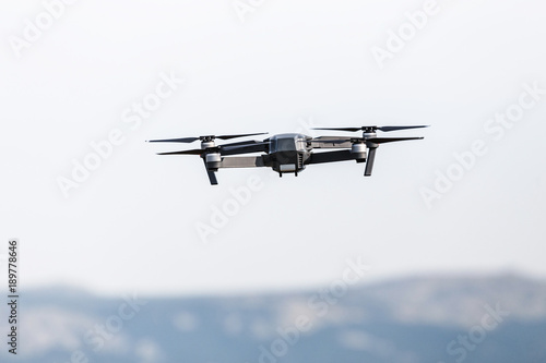 An aerial view of a flying multi-copter drone in the sky