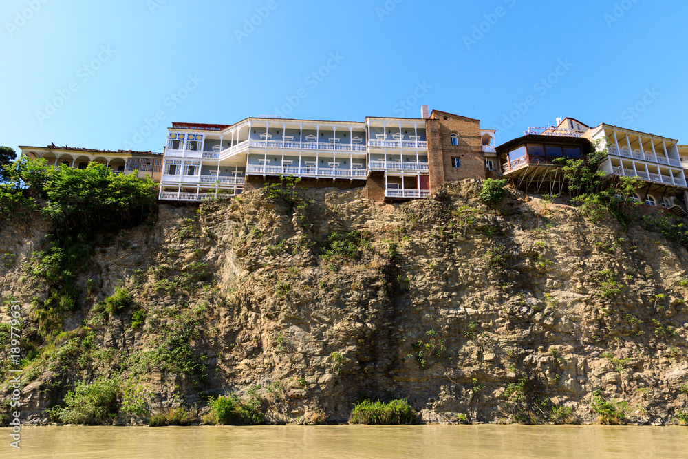 Houses on the edge of a cliff above the river Kura. Tbilisi, the historic city center