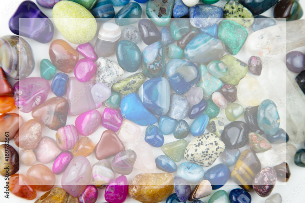 various tumbled bright coloured semi precious gemstones with copy space various tumbled bright coloured semi precious gemstones with copy space