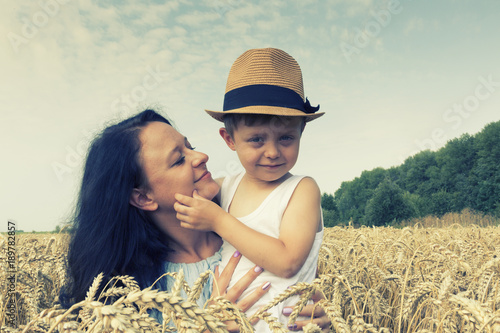 Happy family. Mom and son on the wheat field. Front view. © AnastazjaSoroka
