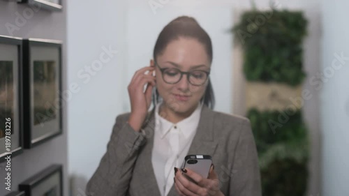 Girl Putting a Headphone On and Walking into the Room